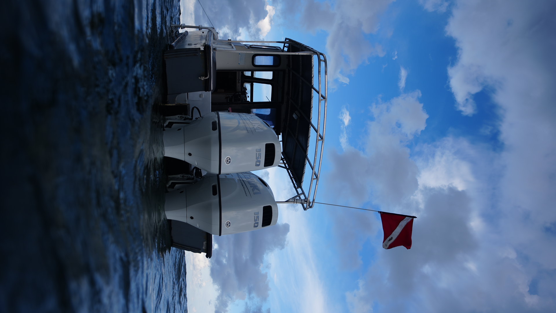 Pilot House boat on the water with twin Suzuki 150 engines