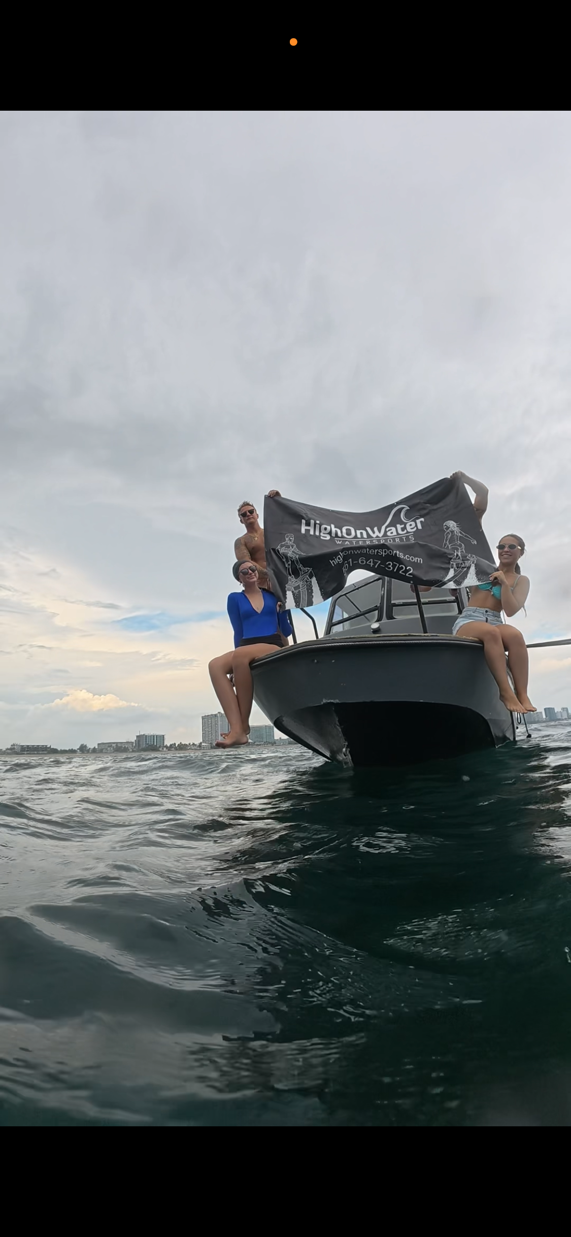 Guests on the snorkel boat holding a High On Water Sports flag