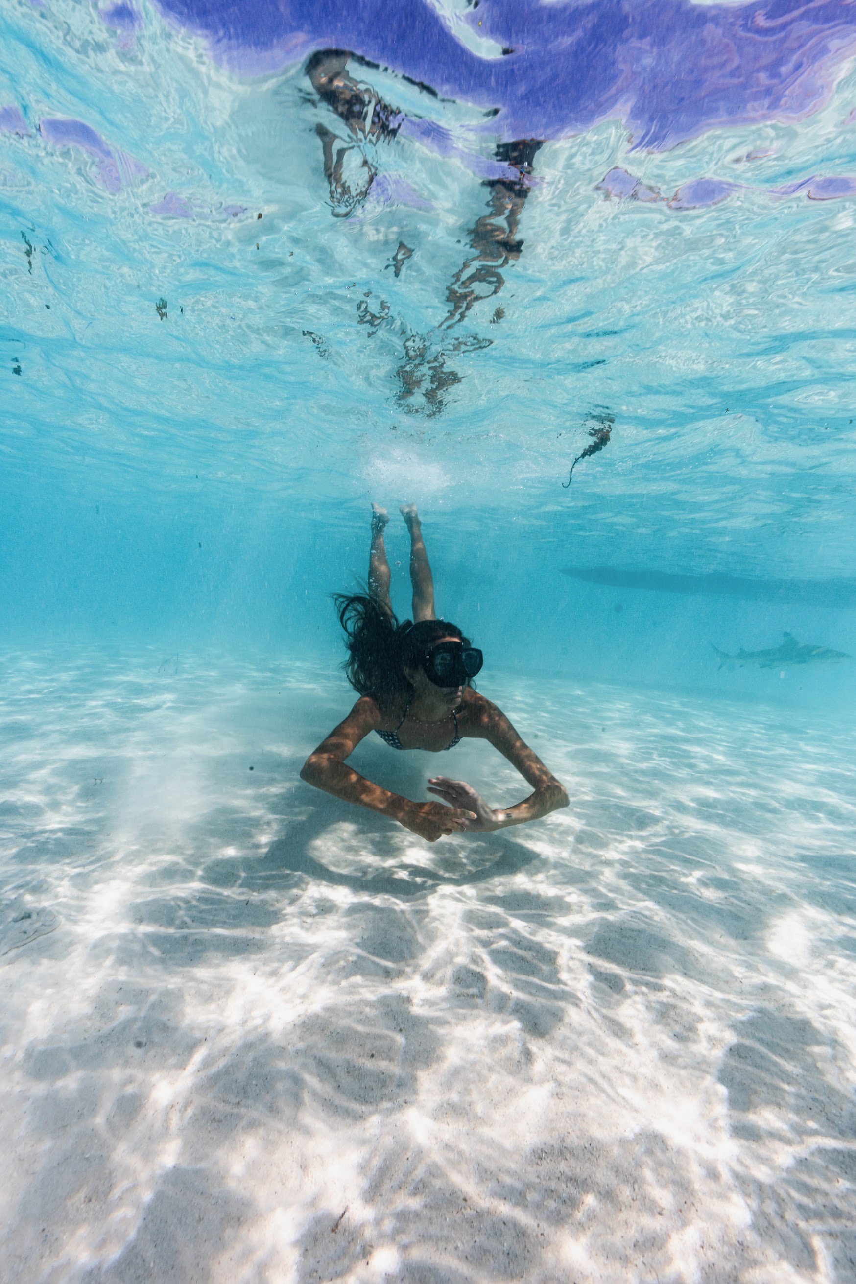 Snorkeler exploring clear water above the sandy seabed